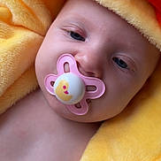 Tallulah is registered to the contest to win money with this photo: baby, blanket, child, closeup, comfort, cute, expression, face, head, infant, orange, pacifier, portrait, rest, skin, sleepy, soft_texture, warm, yellow, young