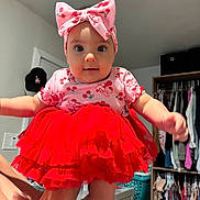 Isabella joined the competition — help win amazing prizes! baby, child, infant, portrait, red_dress, ruffled_dress, pink_bow, headband, cherry_pattern, smiling, indoor, closet, clothing, wardrobe, laundry_basket, dresser, home, sitting, arms_outstretched, fashion