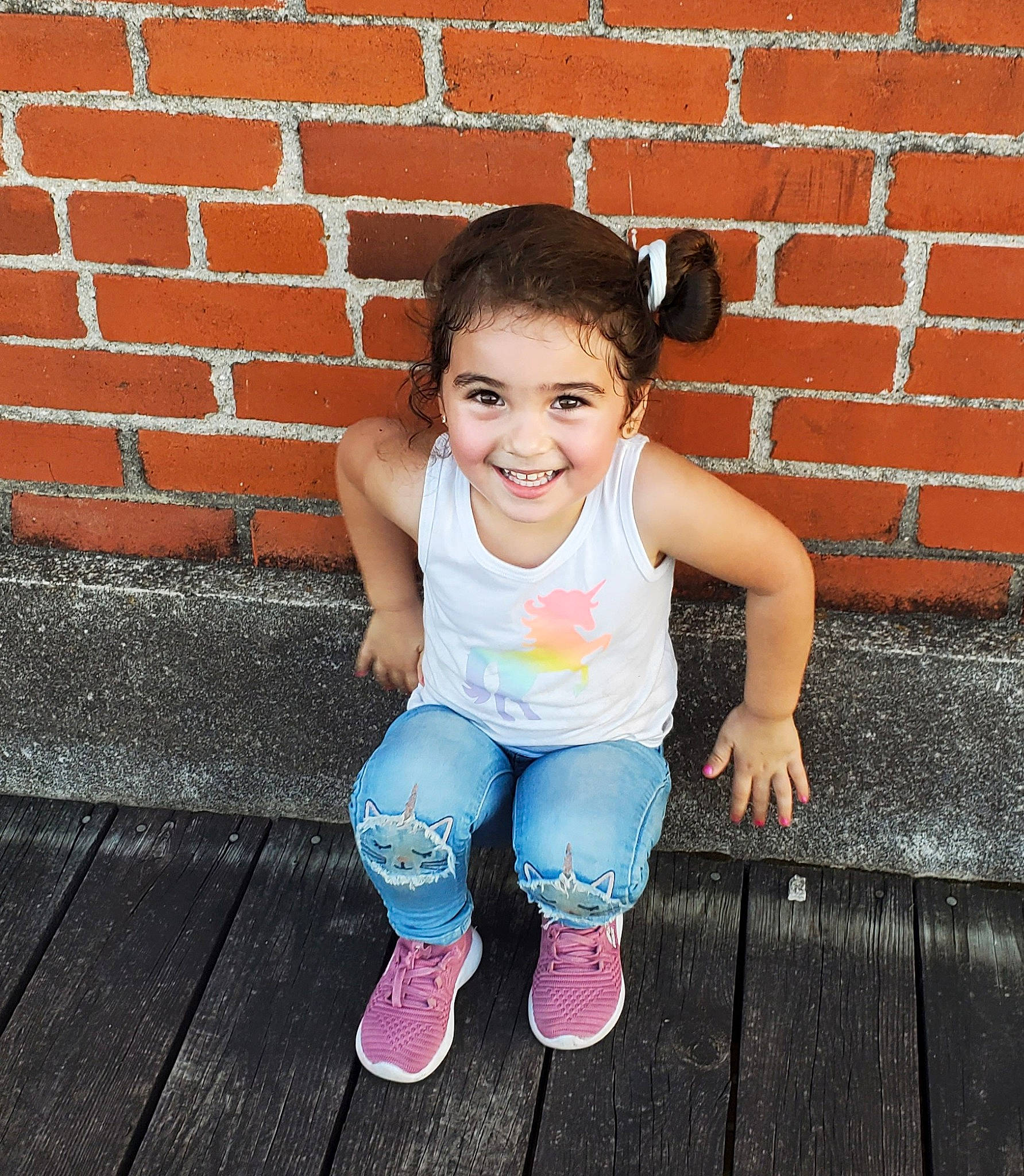 Katalyna is registered to the contest to win money with this photo: baby_toddler_clothing, brick, brickwork, child, denim, electric_blue, face, flash_photography, foot, happy, jeans, joy, leisure, person, pink, skin, smile, street_fashion, t_shirt, thigh