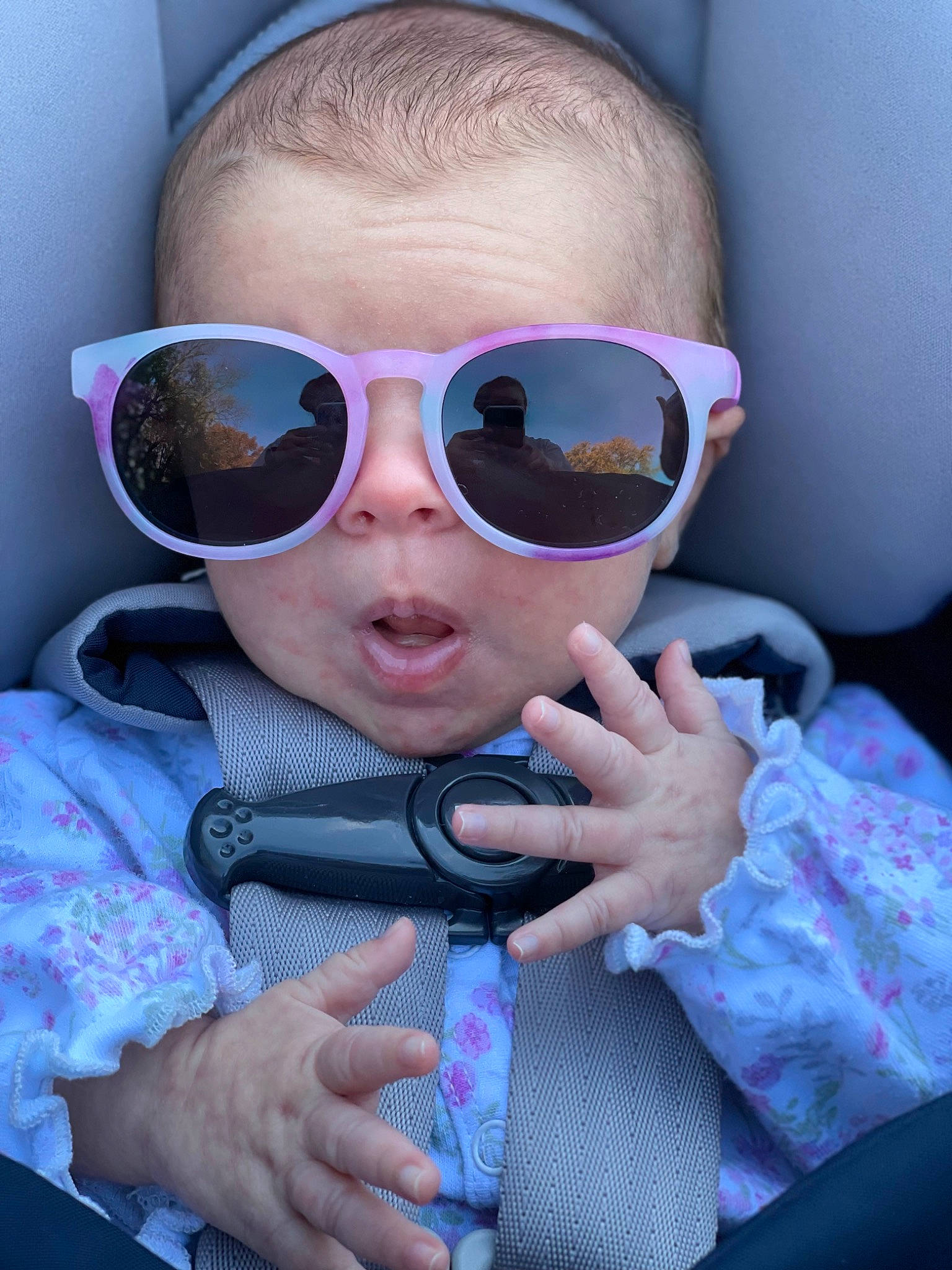 Madeleine is registered to the contest to win money with this photo: blue, cheek, cool, eyewear, fun, gesture, glasses, goggles, headgear, lip, mouth, nose, person, personal_protective_equipment, pink, product, purple, skin, sunglasses, toddler