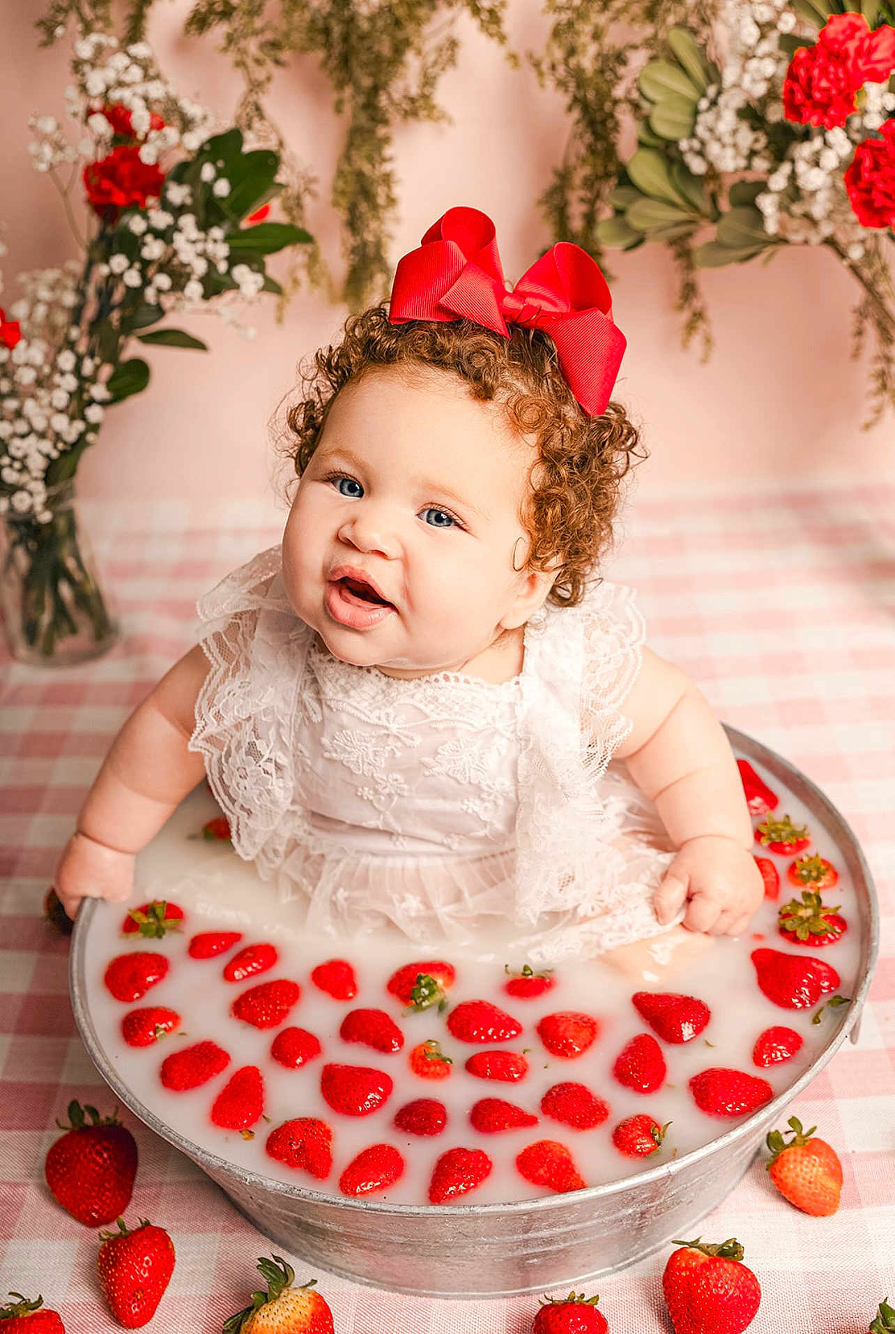 Mila joined the competition — help win amazing prizes! baby, child, curly_hair, red_bow, white_dress, metal_tub, milky_water, strawberries, pink_checkered_tablecloth, flowers, floral_arrangement, vintage_style, portrait, smiling, cute, indoor, decor, happy, sitting, closeup