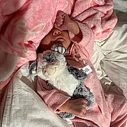 Kiely joined the competition — help win amazing prizes! baby, blanket, pink, sleeping, stuffed_animal, soft_toy, infant, cozy, bed, pajamas, hand, face, cute, child, resting, comfort, fabric, toddler, nap, indoor