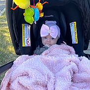 Kiely joined the competition — help win amazing prizes! baby, blanket, car_seat, headband, bow, plush_toys, outdoor, grass, evenflo, infant, cute, pink, black, child, portrait, clothing, toy, baby_accessory, seat, comfort