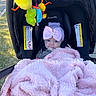 baby, blanket, car_seat, headband, bow, plush_toys, outdoor, grass, evenflo, infant, cute, pink, black, child, portrait, clothing, toy, baby_accessory, seat, comfort