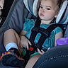 Elizabeth joined the competition — help win amazing prizes! child, toddler, car_seat, seatbelt, blue_dress, sneakers, footwear, hair_buns, car_interior, seat, safety_harness, young_child, portrait, serious_expression, automobile, window, purple_sippy_cup, clothing, person, indoor