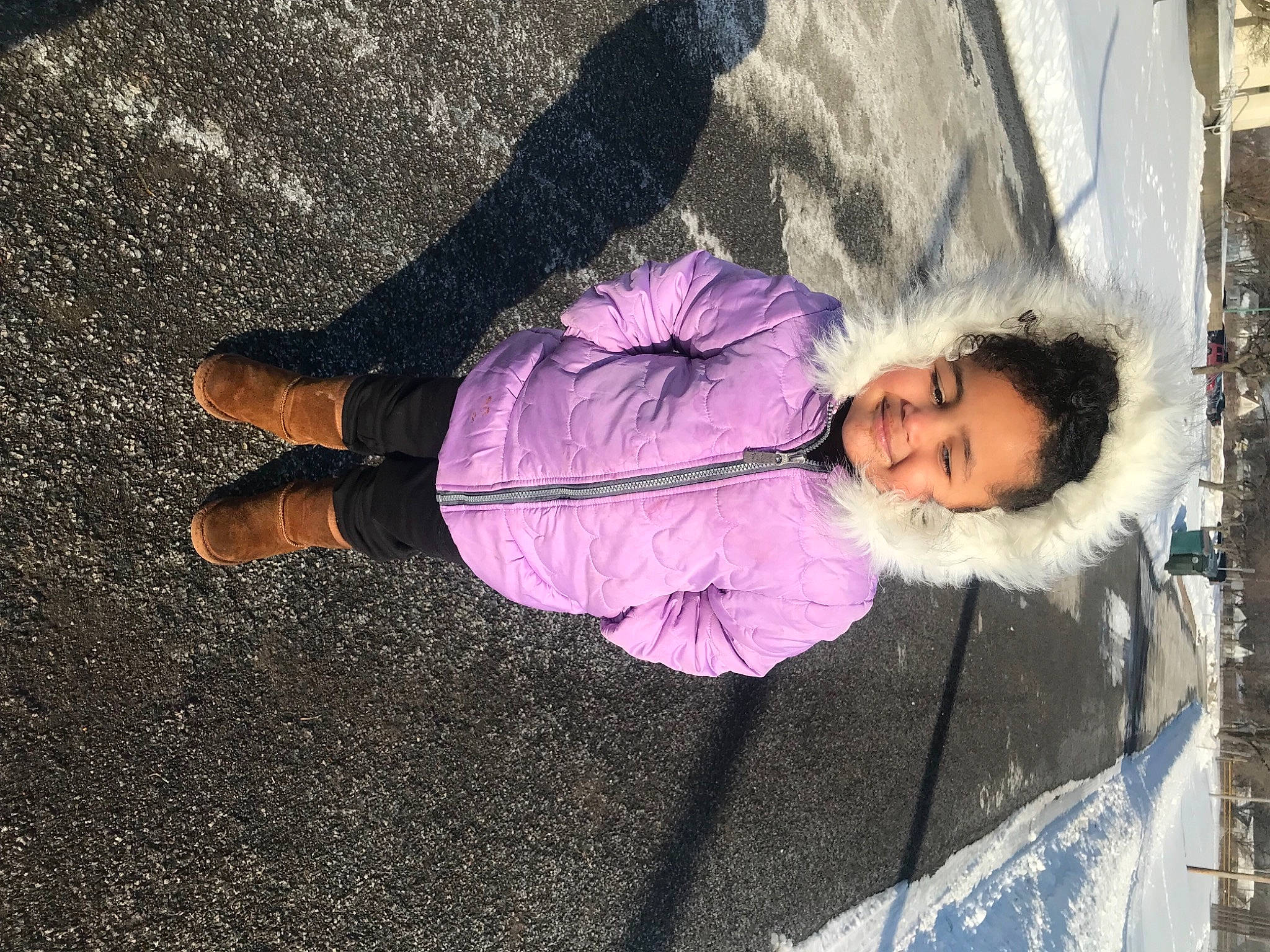 Carina is registered to the contest to win money with this photo: asphalt, child, city, flooring, freezing, fun, human_leg, joy, leisure, magenta, pedestrian, person, purple, road_surface, shadow, sidewalk, smile, street, toddler, tree