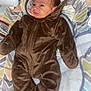 James is registered to the contest to win money with this photo: baby, blanket, bonnet, clothing, coat, cushion, face, happy, hat, head, homedecor, hood, infantbed, jacket, pants, person, photography, portrait, sleeve, velvet