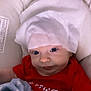 James is registered to the contest to win money with this photo: baby, bed, blanket, bonnet, cap, clothing, couch, crib, cushion, face, furniture, hat, head, homedecor, infantbed, newborn, person, photography, portrait, t_shirt