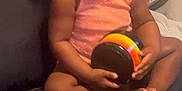 Jade is registered to the contest to win money with this photo: baby, ball, couch, cushion, electronics, face, flower, football, furniture, head, homedecor, indoors, person, photography, plant, portrait, sitting, soccer, soccerball, sport