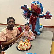 Jade is registered to the contest to win money with this photo: adult, ball, birthdaycake, cake, child, cream, dessert, face, female, food, football, furniture, girl, head, icing, male, man, people, person, table