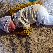 Aurelia joined the competition — help win amazing prizes! newborn, baby, sleeping, pajamas, hat, blanket, soft, cozy, animal_print, yellow_cloth, resting, indoors, infant, peaceful, cute, child, person, fabric, texture, portrait