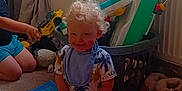 Cohen joined the competition — help win amazing prizes! child, toddler, toy, carpet, laundry_basket, window, curly_hair, smile, indoor, sock, plastic_toy, slippers, person, playing, blue_toy, yellow_toy, curtain, radiator, floor, basket