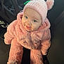 Leya a rejoint le concours — aidez-le/la à gagner de superbes lots ! baby, child, pink_clothing, hat, pom_poms, car_seat, smiling, happy, cute, indoor, seat, clothing, person, portrait, warm, fuzzy, infant, headwear, cozy, car_interior