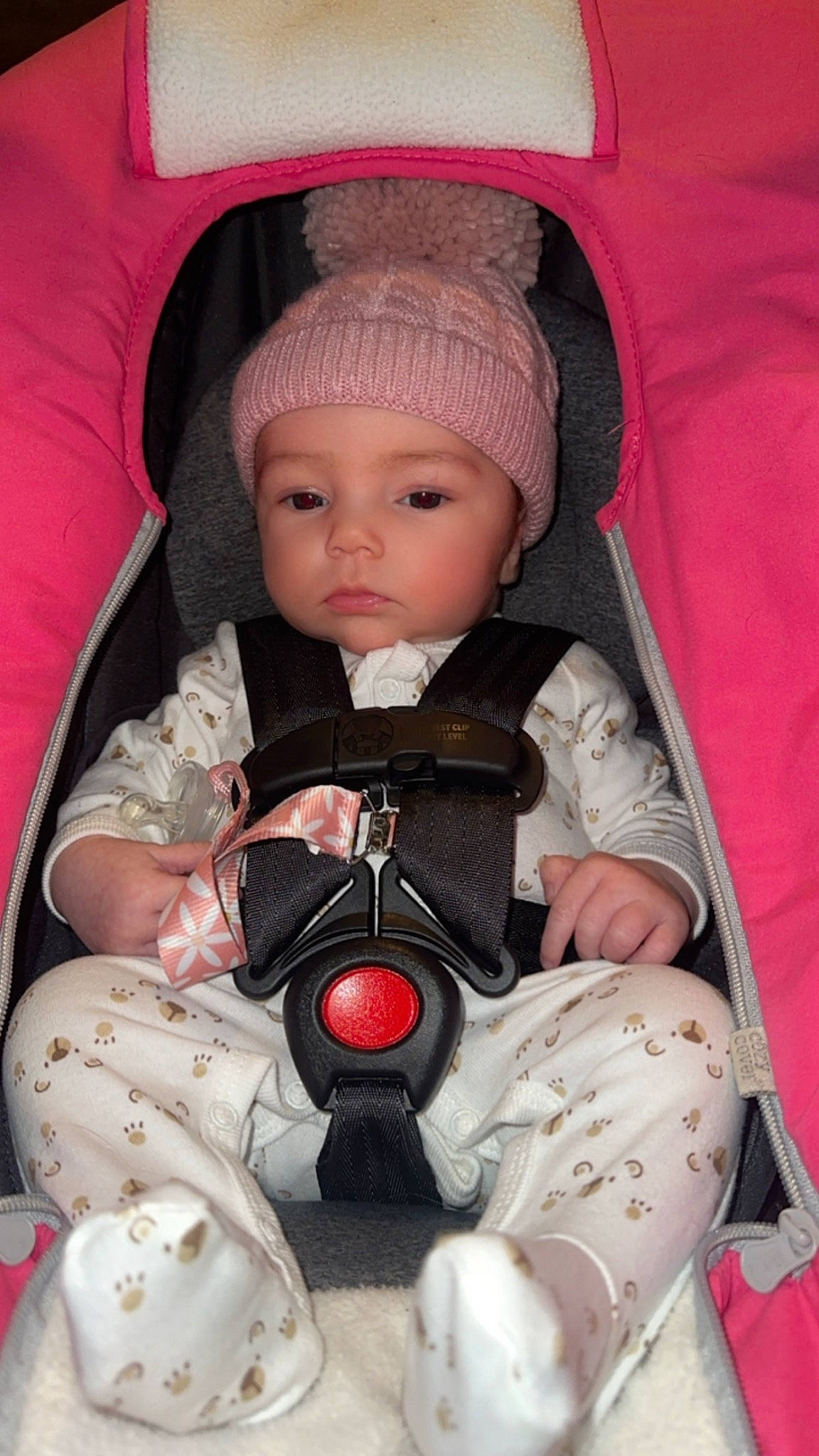 Indie Rose is registered to the contest to win money with this photo: baby, baby_carriage, baby_products, baby_safety, baby_toddler_clothing, cap, car_seat, carmine, cheek, child, comfort, facial_expression, headwear, lap, person, pink, product, sitting, skin, textile