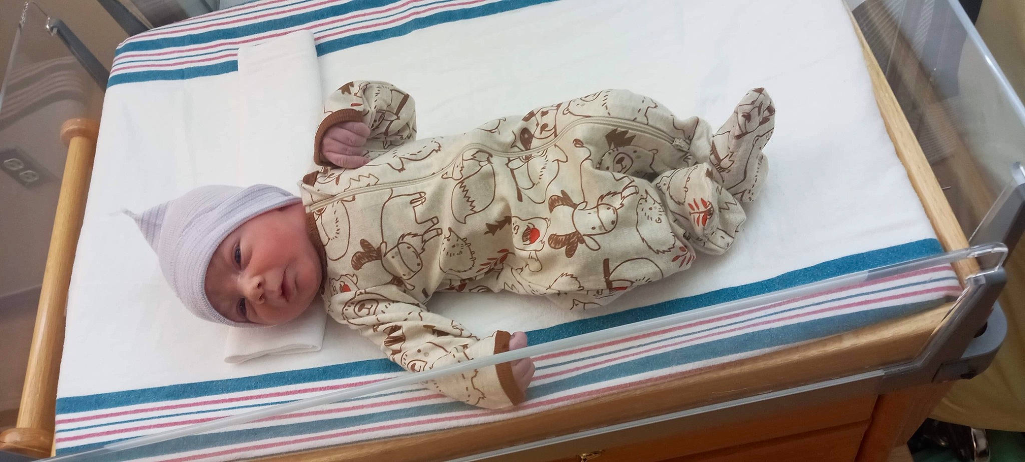 Elijah is registered to the contest to win money with this photo: art, baby, baby_products, baby_sleeping, baby_toddler_clothing, bedding, child, comfort, fashion_accessory, flooring, headwear, linens, pattern, person, room, sculpture, sitting, sleeve, statue, textile