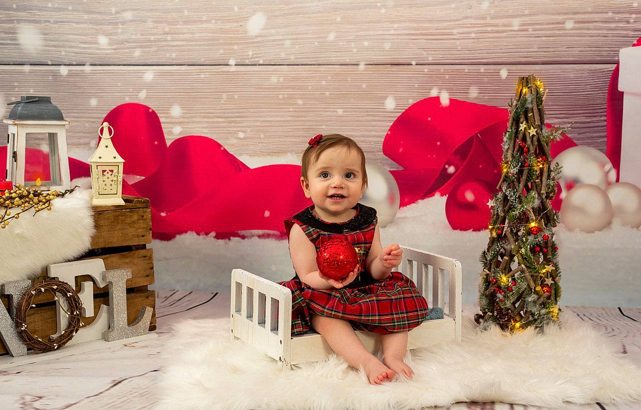 Jessica joined the competition — help win amazing prizes! baby, child, christmas, christmas_decoration, christmas_eve, fictional_character, happy, holiday, interior_design, joy, person, pink, red, room, sitting, smile, toddler, tree, winter