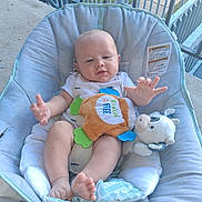 Matthew joined the competition — help win amazing prizes! baby, infant, child, bouncer, seated, outdoor, porch, deck, railing, plush_toy, stuffed_animal, toy, blanket, white_clothing, bare_feet, smiling, face, portrait, backyard, daylight