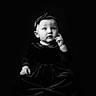 baby, child, portrait, black_and_white, dress, headband, sitting, velvet, studio, thoughtful, cute, infant, one_person, indoor, monochrome, fashion, young_child, expression, face, hands