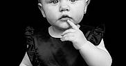 Sarah joined the competition — help win amazing prizes! baby, black_background, child, curious, cute, expression, fashion, indoor, isolated, looking_at_camera, minimalist, monochrome, one_person, portrait, short_hair, sleeveless, studio_photo, thinking, toddler, young_child