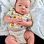 baby, infant, diaper, clothing, cute, pout, hands, fluffy_blanket, animal_print, skin, legs, sitting, portrait, indoors, soft_texture, adorable, child, young, expression, comfortable