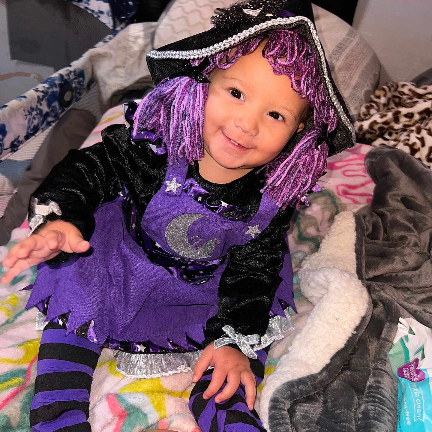 Delilah joined the competition — help win amazing prizes! baby, bed, bedroom, bodypart, clothing, costume, cushion, face, finger, furniture, hand, hat, head, homedecor, indoors, person, photography, portrait, purple, room