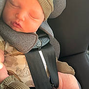 Isaiah is registered to the contest to win money with this photo: newborn, baby, sleeping, car_seat, harness, infant, portrait, knit_hat, clothing, socks, mittens, vehicle, car_interior, seated, peaceful, resting, face, closed_eyes, cozy, photography