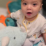 Luca joined the competition — help win amazing prizes! baby, child, childhood, clothing, cute, elephant, face, happy, indoor, infant, onesie, person, plush_toy, portrait, rhino, smiling, soft_toy, stuffed_animal, toy, young