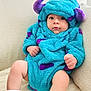 baby, blue, child, costume, curious, cute, expression, fist, fuzzy, hood, horns, indoors, infant, legs, monster, portrait, purple, sitting, socks, soft