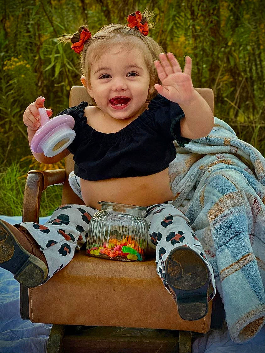 Serenity joined the competition — help win amazing prizes! baby, baby_toddler_clothing, child, face, facial_expression, fun, grass, hairstyle, happy, joy, leaf, leisure, pattern, people_in_nature, person, photograph, pink, plant, sitting, smile