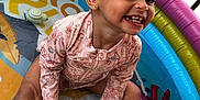 Merlyn is registered to the contest to win money with this photo: toddler, child, smiling, splashing, inflatable_pool, water, swimsuit, toy, elf_doll, outdoor, play, happy, cute, summer, fun, colorful, sitting, baby, joyful, skin