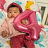 baby, infant, pink_balloon, number_4, blanket, animal_print, headband, leggings, polka_dots, cozy_clothing, baby_boots, indoors, child, cute, portrait, holding_object, sitting, colorful, soft_texture, celebration