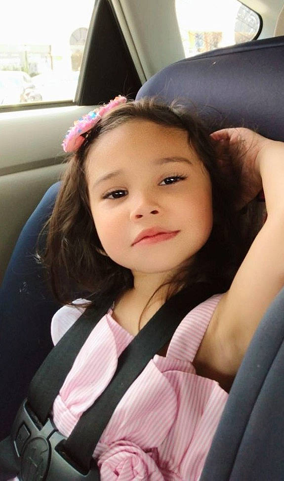 Noel is registered to the contest to win money with this photo: auto_part, automotive_design, beauty, black_hair, brown_hair, car_seat, dress, eyelash, flash_photography, fun, happy, luxury_vehicle, person, pink, sitting, smile, steering_wheel, thigh, toddler, vehicle_door