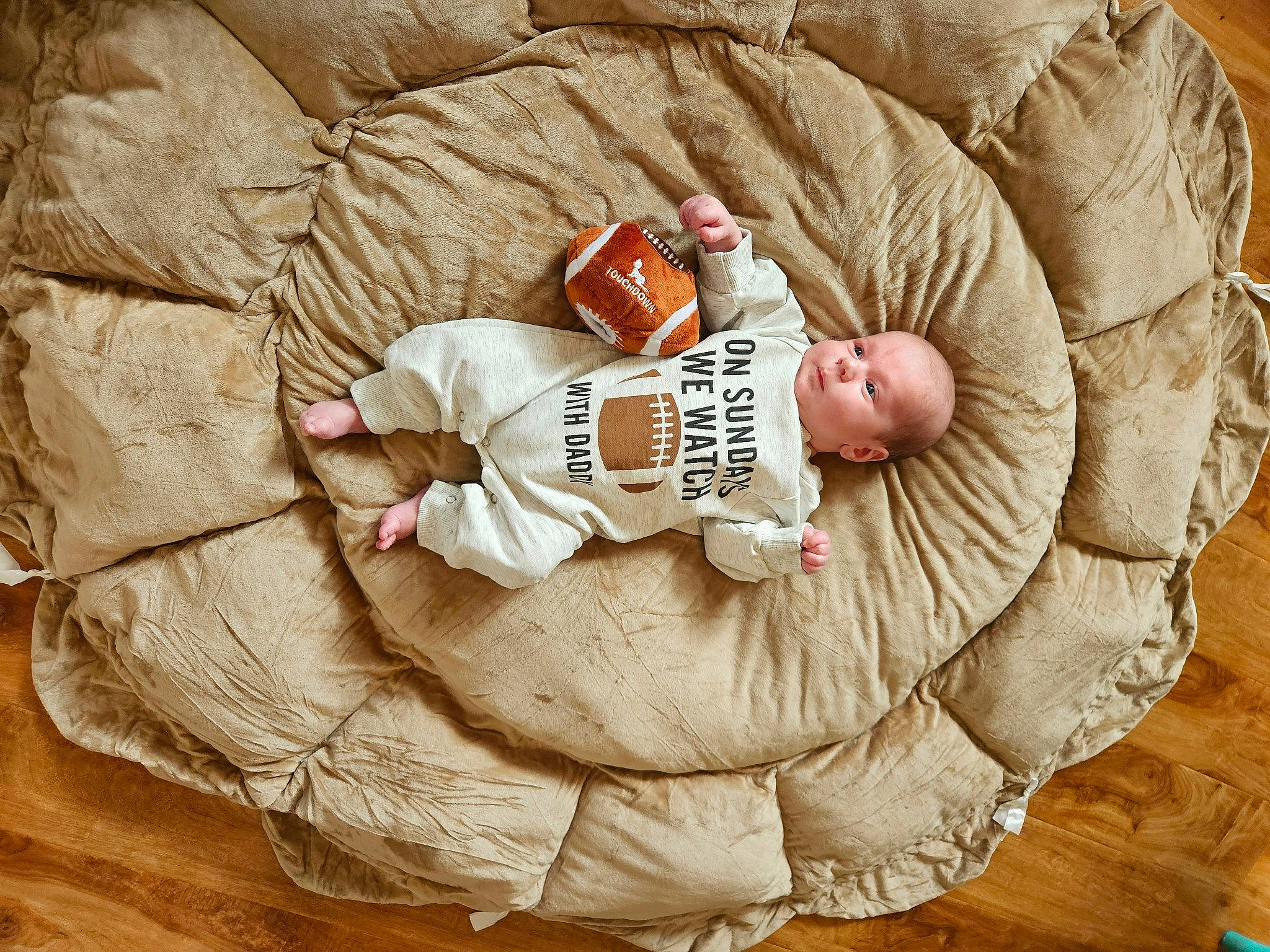 Major is registered to the contest to win money with this photo: baby, baby_sleeping, baby_toddler_clothing, child, comfort, flooring, font, foot, fur, happy, hardwood, linens, pattern, peach, person, sitting, sleeve, textile, toddler, wood