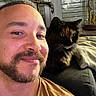 Kitten participe au concours pour gagner de l'argent avec cette photo : man, person, cat, tortoiseshell_cat, selfie, portrait, indoor, couch, sitting, face, beard, smiling, pet, companion, whiskers, fur, eyes, lamp, window, homedecor
