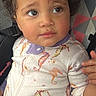 toddler, child, car_seat, onesie, seahorse_pattern, curly_hair, expressive_eyes, baby_clothing, indoor, seat_belt, colorful, geometric_pattern, candid, portrait, young_child, cute, person, sitting, car_interior, closeup