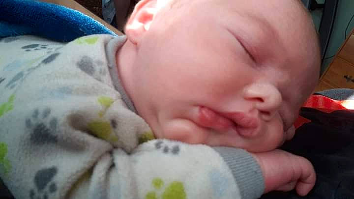 Zachary is registered to the contest to win money with this photo: baby, bedtime, birth, cheek, child, face, head, lip, mouth, nap, nose, person, skin, sleep, toddler