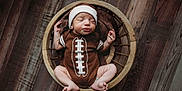 Xavier joined the competition — help win amazing prizes! adorable, baby, baby_boy, basket, brown_clothing, child, cozy, cute, football_onesie, headband, indoors, infant, newborn, peaceful, portrait, resting, sleeping, small_feet, wood_texture, wooden_floor