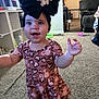 Kynlee joined the competition — help win amazing prizes! toddler, child, living_room, carpet, toy, baby_gate, sofa, black_bow, pink_dress, heart_pattern, smile, motion_blur, indoor, furniture, person, floor, baby, play, home, cute