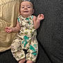 Bentley is registered to the contest to win money with this photo: baby, infant, couch, pillow, romper, toy_story, clothing, smile, relaxed, indoor, child, person, feet, hand, face, comfort, seated, fabric, home, cute