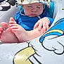 Bentley is registered to the contest to win money with this photo: baby, infant, sleeping, hat, swimsuit, pool_float, water, hands, feet, sunhat, cartoon, colorful, cute, child, outdoor, summer, relaxing, skin, peaceful, toy