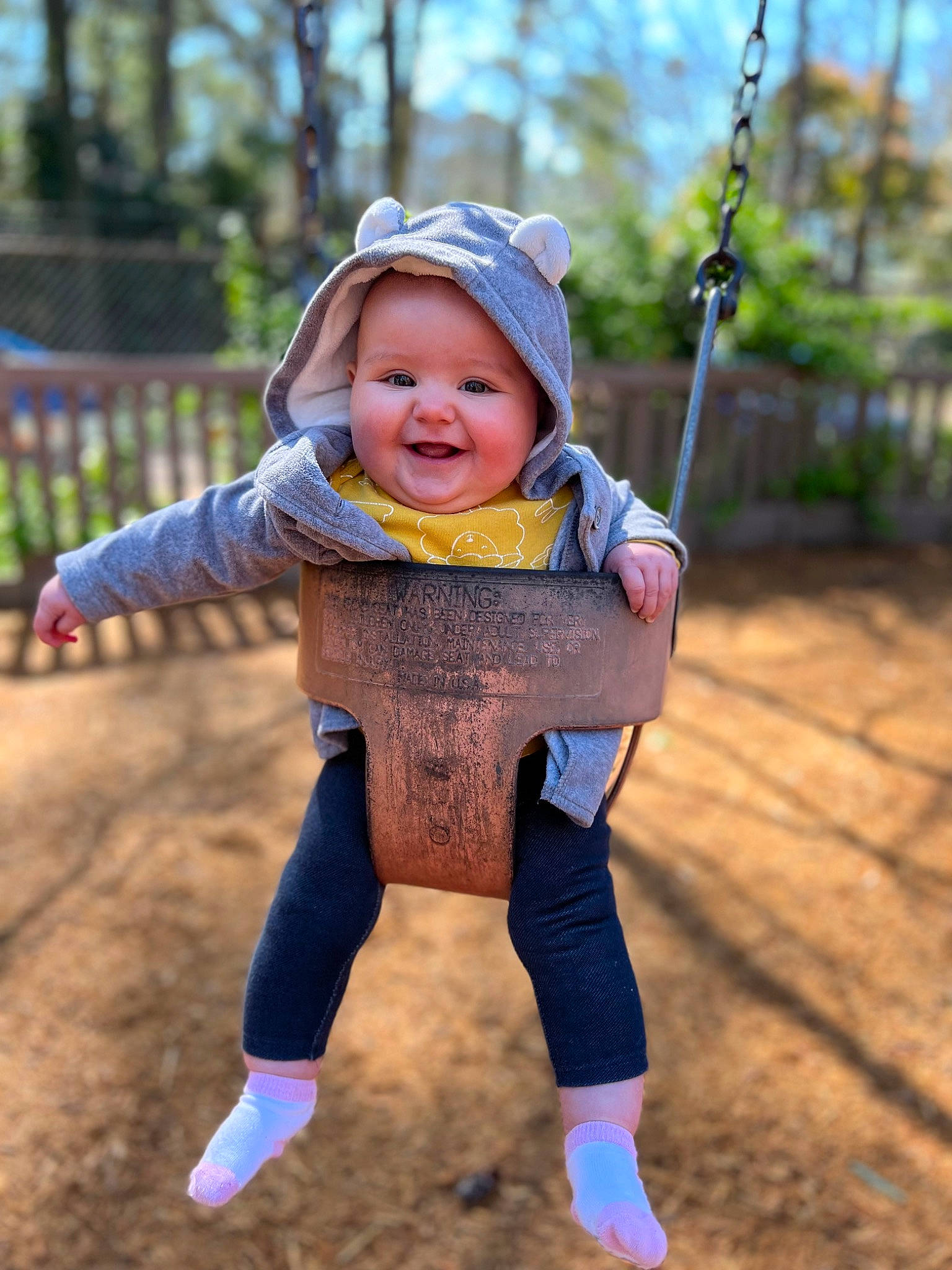 Cecilia is registered to the contest to win money with this photo: baby, baby_toddler_clothing, eye, face, fun, gesture, grass, hand, happy, headwear, joy, leisure, nature, people_in_nature, person, playground, public_space, skin, sleeve, smile