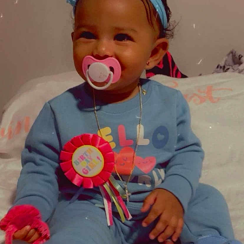 Azariah Leah is registered to the contest to win money with this photo: accessories, baby, bed, cap, clothing, coat, earring, electronics, face, furniture, hat, head, jacket, jewelry, necklace, person, photography, portrait, purple, sitting