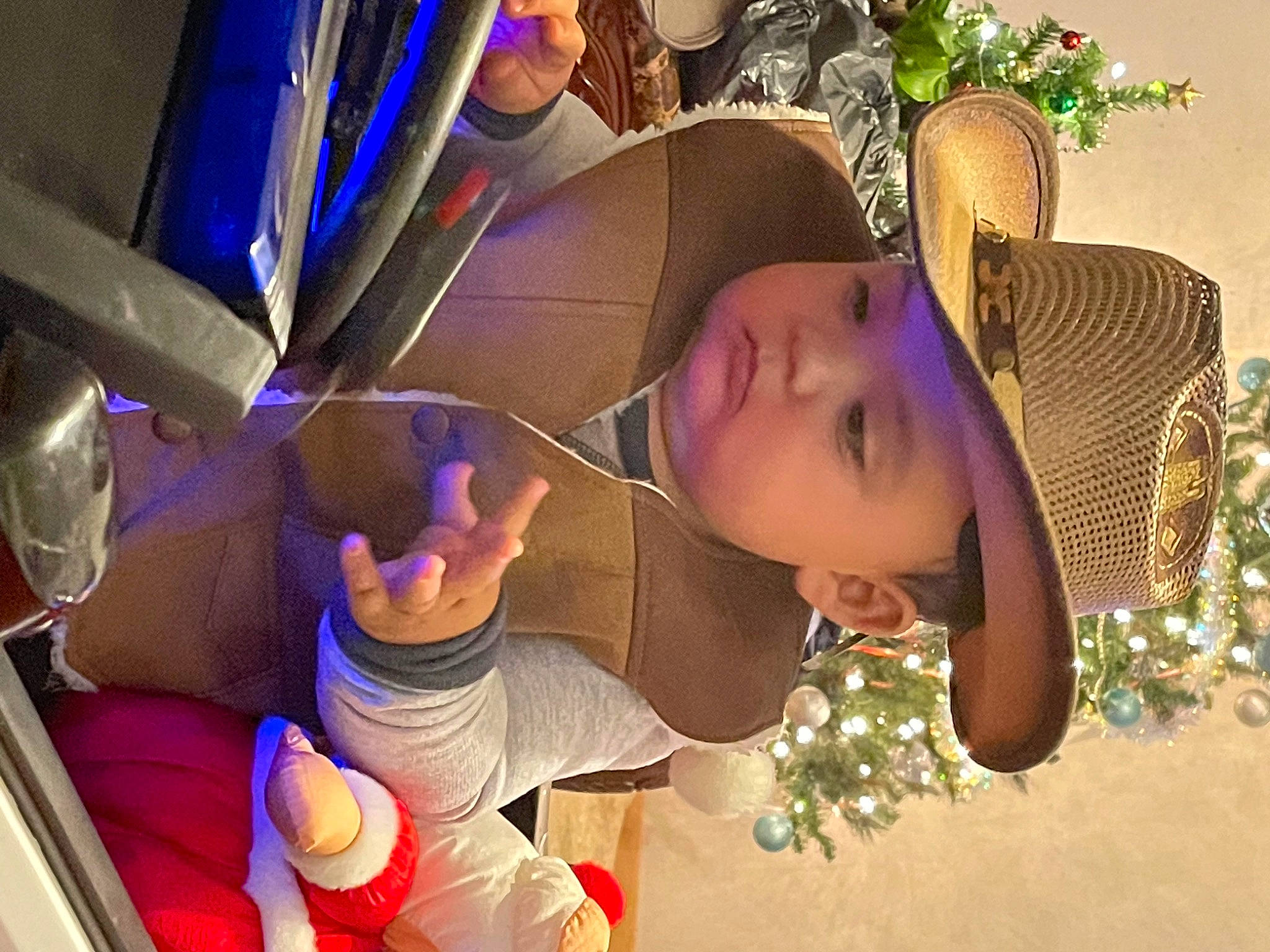 Jaime is registered to the contest to win money with this photo: animation, auto_part, car_seat, child, event, eyewear, fashion_accessory, fun, hand, happy, hat, head, headwear, leisure, person, purple, room, sitting, toddler, tree