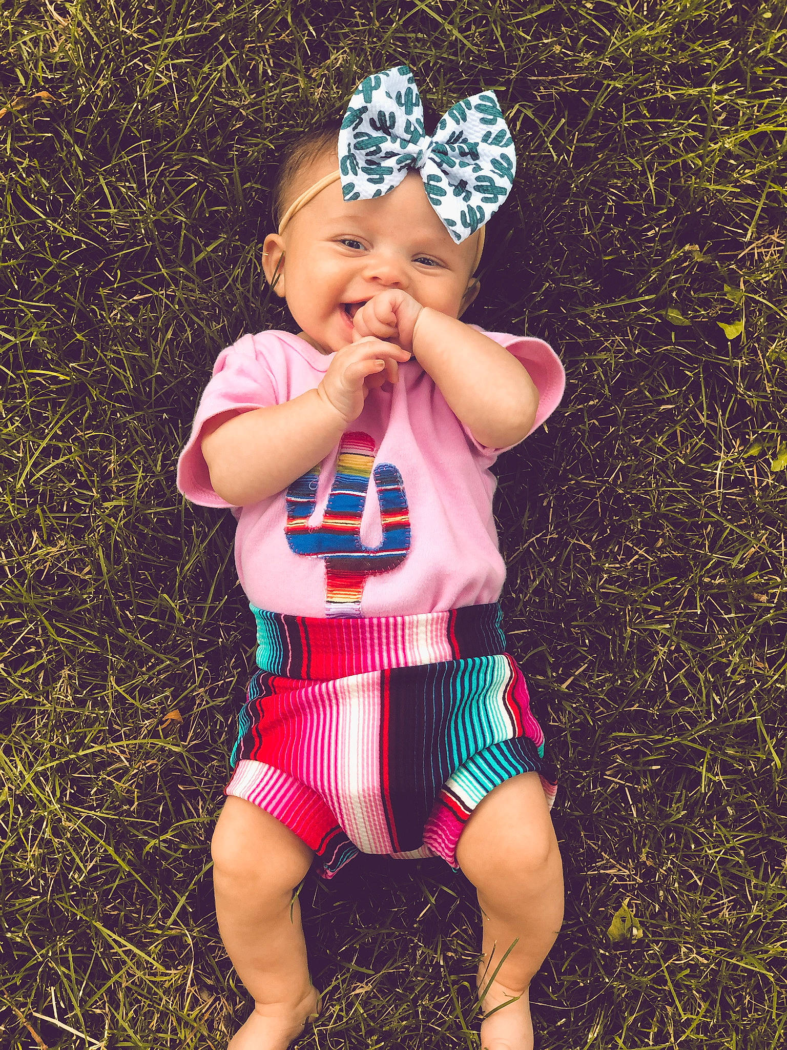 Aislynn joined the competition — help win amazing prizes! baby, baby_toddler_clothing, cap, child, cool, electric_blue, grass, happy, head, headband, headgear, headpiece, headwear, people_in_nature, person, pink, summer, thigh, tiara, toddler