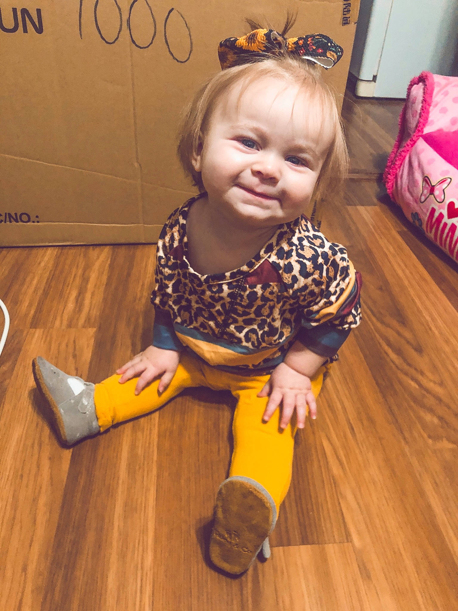 Aislynn is registered to the contest to win money with this photo: baby_toddler_clothing, child, dress, floor, flooring, hair, happy, hardwood, human_leg, iris, joy, knee, laminate_flooring, person, skin, sleeve, smile, standing, toddler, varnish