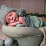 newborn, baby, sleeping, hat, blanket, bucket, cozy, wrapped, indoors, soft_lighting, bokeh, decor, wooden_floor, cute, peaceful, infant, portrait, resting, green, warm