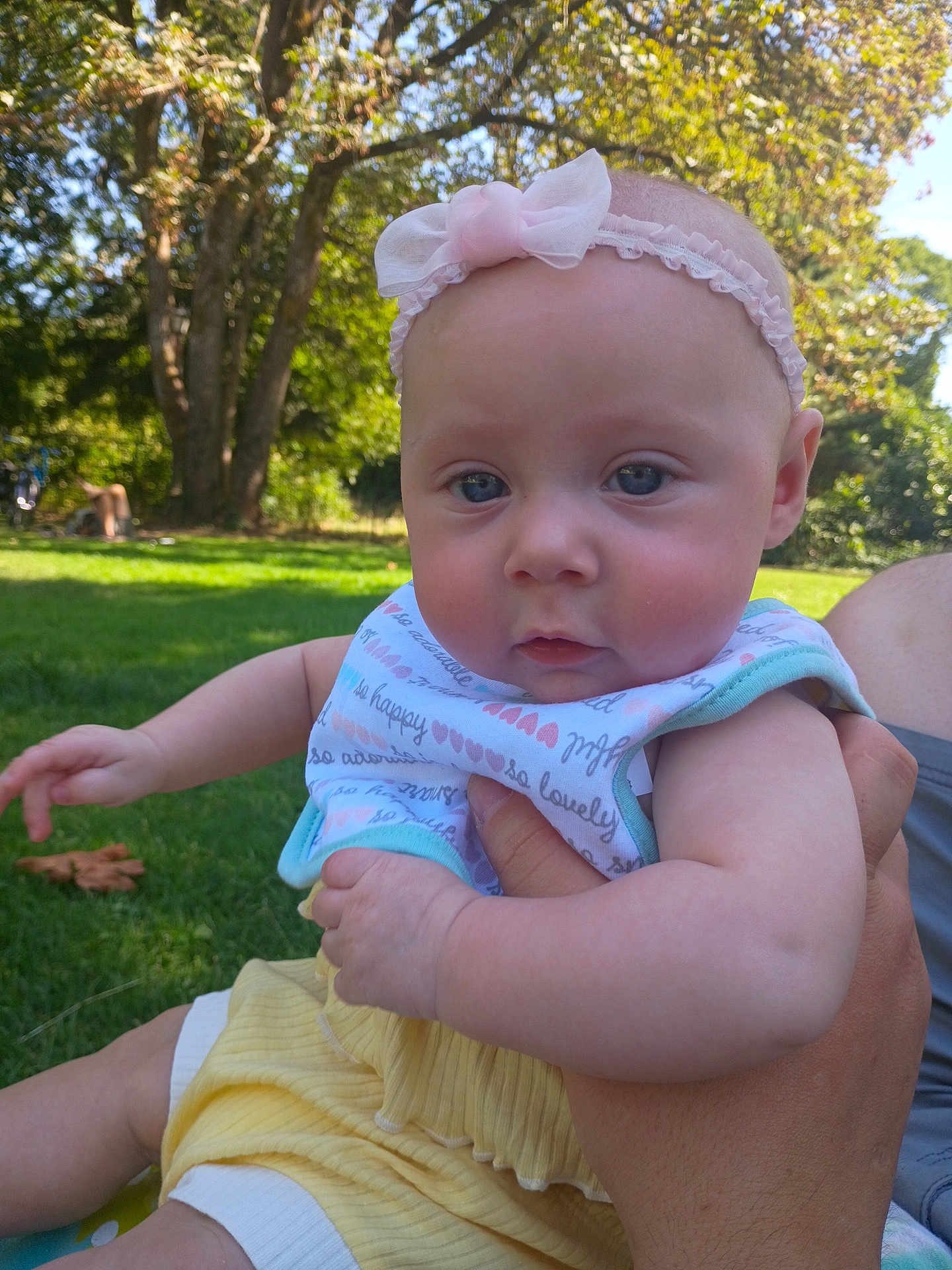 Lilyuana joined the competition — help win amazing prizes! baby, child, outdoor, grass, tree, headband, bib, hand, person, summer, cute, nature, greenery, sunlight, infant, portrait, skin, face, clothing, holding