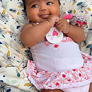 Dayana participe au concours pour gagner de l'argent avec cette photo : baby, infant, child, cushion, toy, clothing, pink, white, bandage, smiling, cute, face, hands, sitting, indoor, soft, patterned, skin, playful, relaxed