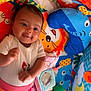 Dayana participe au concours pour gagner de l'argent avec cette photo : baby, infant, playpen, toys, plush, colorful, smiling, cute, child, indoor, happy, clothing, mirror, orange_ball, green_ball, blue_elephant, lion_print, carpet, pink_pants, white_shirt