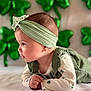 Hazel is registered to the contest to win money with this photo: baby, balloons, bokeh, cheek, child, cute, forehead, green, hand, headband, holiday, infant, lying_down, onesie, outfit, portrait, profile, ruffle, shamrock, soft_light